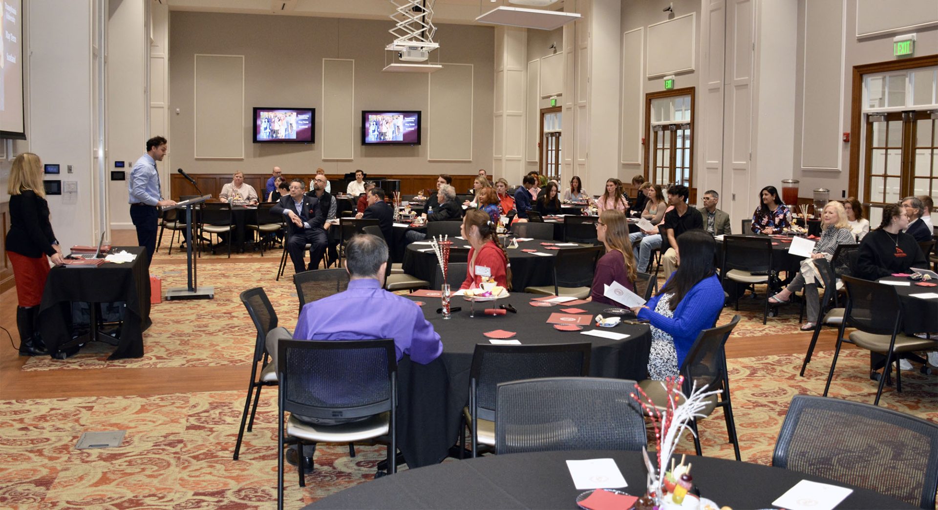 people watching a presentation in a large room