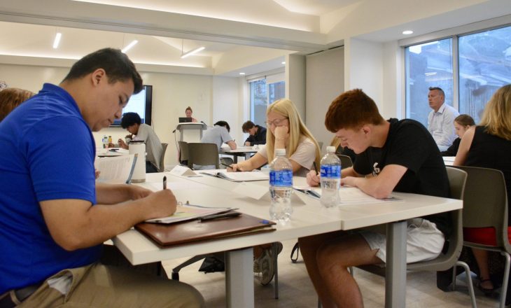 students working around a table at an Entrepreneurship Camp