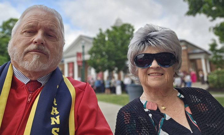 two people posing for a photo at a graduation ceremony