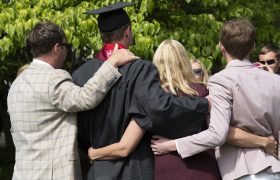 back of a recent grad and his family
