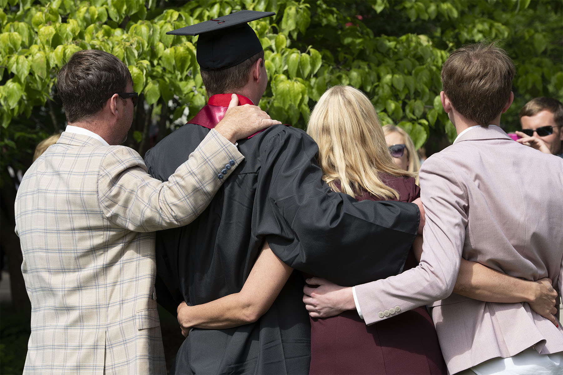 back of a recent grad and his family