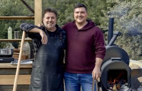 two people in front of a smoker