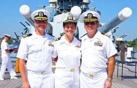 three navy doctors posing on a ship