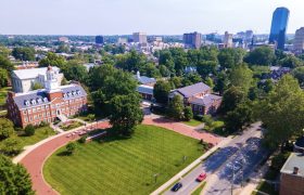 a college campus with a city skyline in the background