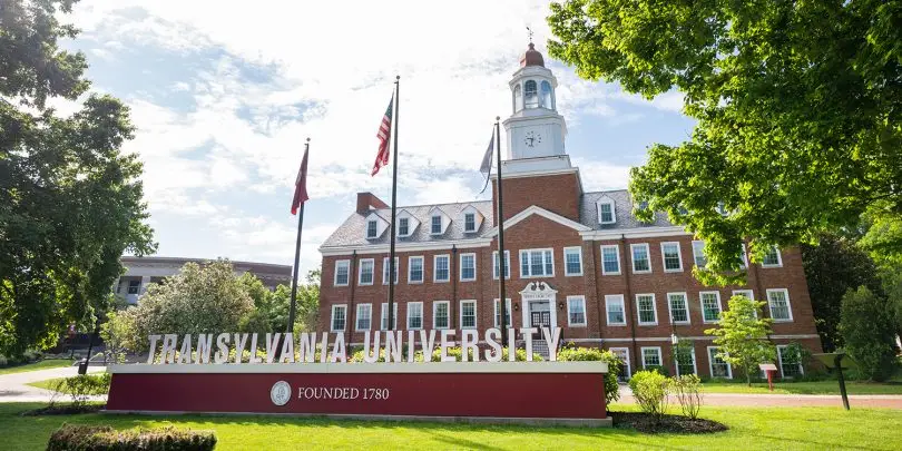 Transylvania University sign and flags in front of Carpenter Academic Center