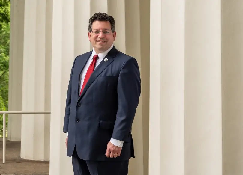 Transylvania President Brien Lewis standing next to columns of historic Old Morrison