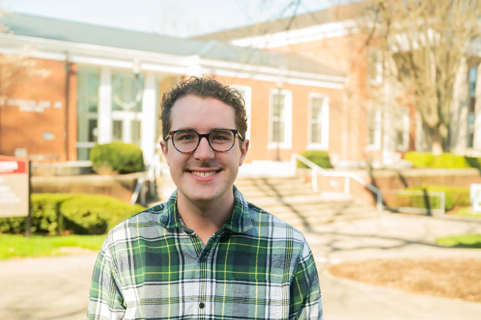 Image of Josh Porter in front of the campus library