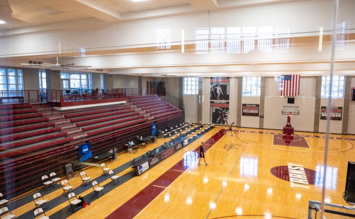 big ass fan mounted to ceiling above gymnasium.