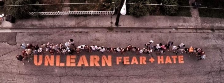 Unlearn Fear and Hate stencil from above