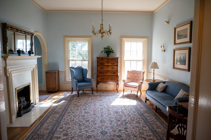 Graham Cottage interior - windows, fireplace, blue sofa