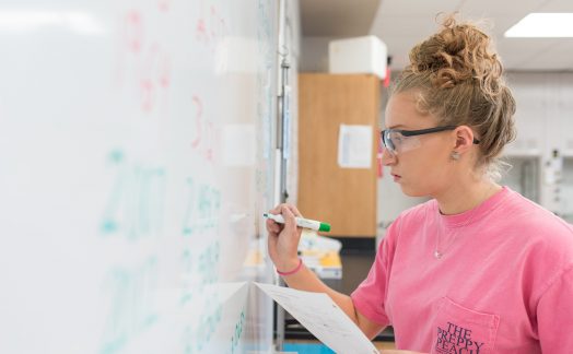 student working at whiteboard