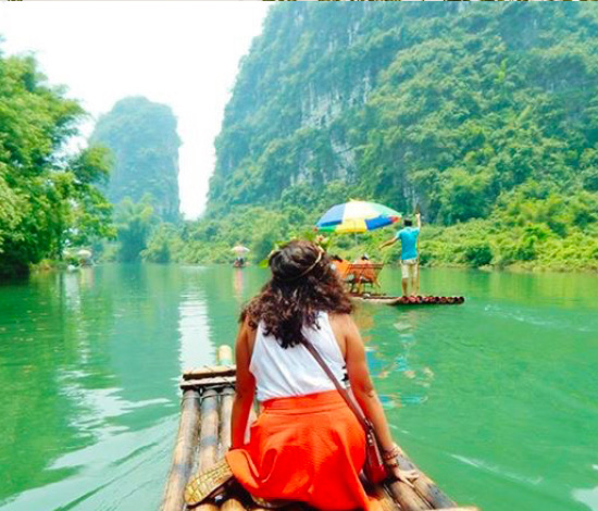 students floating in boats on a river