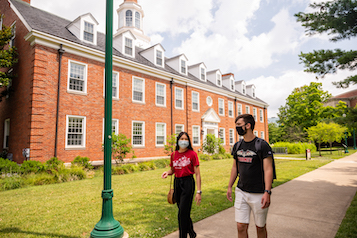Students walking on campus in masks