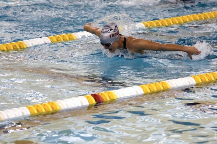 student competing in swimming event
