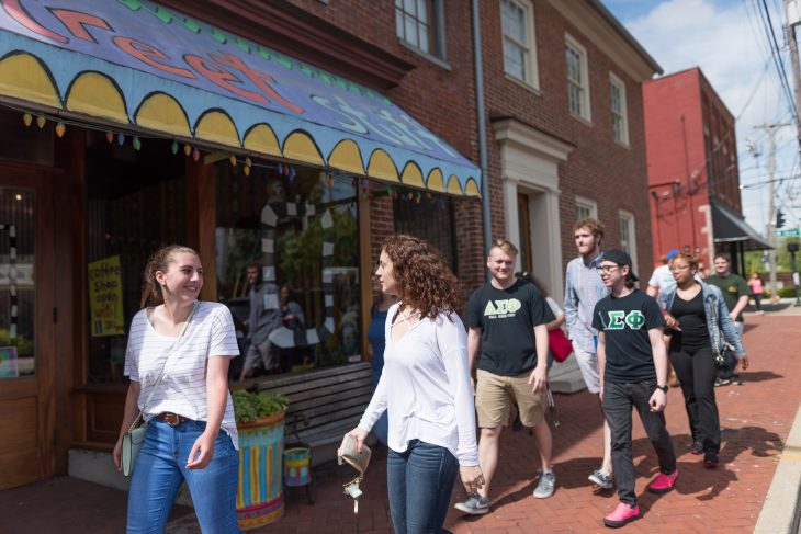 Students walking past stores on lexington sidewalk