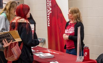 students gathering in front of the transy table at a college fair