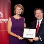 Danielle Clore holding award with Brien Lewis