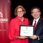 Lisbon Hardy holding award with Brien Lewis