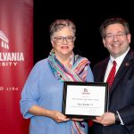 Mary Rankin holding award with Brien Lewis
