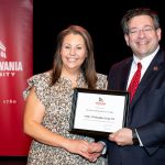 Ashley King holding award with Brien Lewis