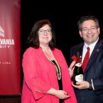 Brien Lewis and Alumna holding a bottle of wine