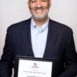 portrait of Erwin Roberts holding award