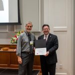 alumnus posing with president brien lewis