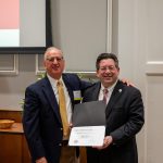 alumnus posing with president brien lewis