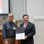 alumnus posing with president brien lewis