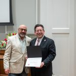 alumnus posing with president brien lewis