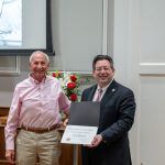 alumnus posing with president brien lewis