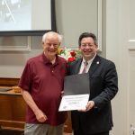 alumnus posing with president brien lewis