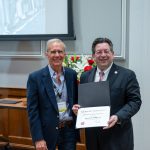 alumnus posing with president brien lewis