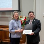 alumna posing with president brien lewis