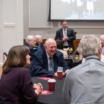 Alumni sitting at tables