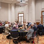 Alumni sitting at tables