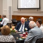 alumni sitting at table