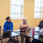 Older lady speaks with students in classroom