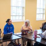 Older lady speaks with students in classroom