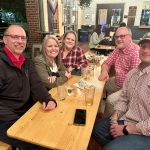 alumni pose for photo