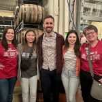 alumni pose for photo