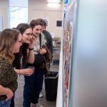 group looking a photos on the wall