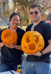 students showing off finished jack-o-lanterns