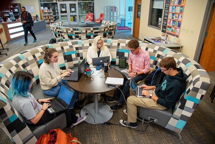 students gathered at a library table