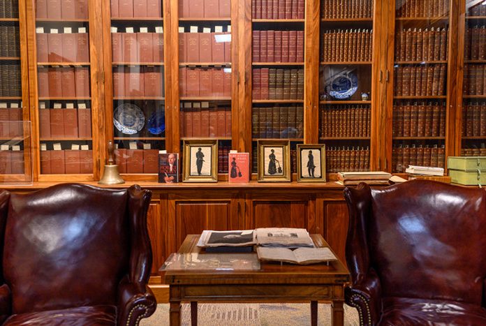 sitting area with chairs and wooden shelves