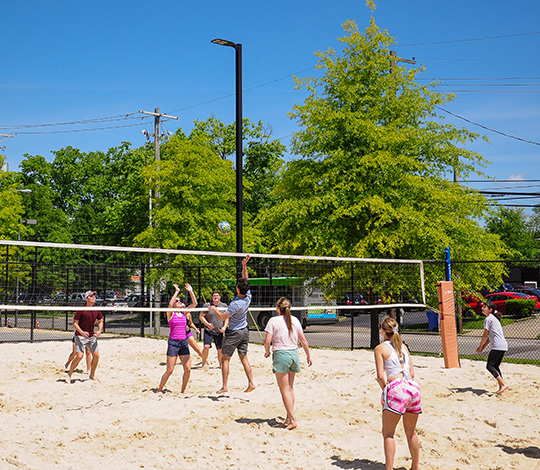 students playing volleyball on campus facilities