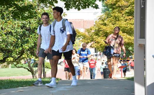 students on campus walking between classes