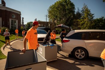 move-in day volunteers helping new arrivals into residence halls