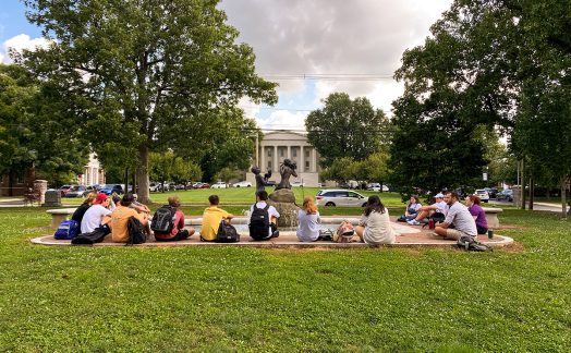 students seated around a fountain in Gratz Park