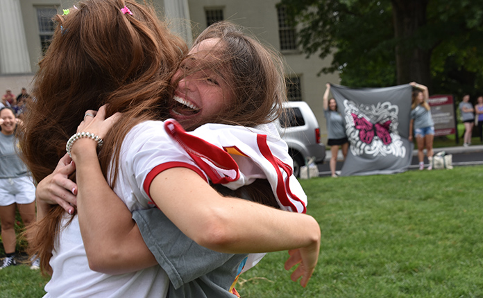 excited sorority members hugging